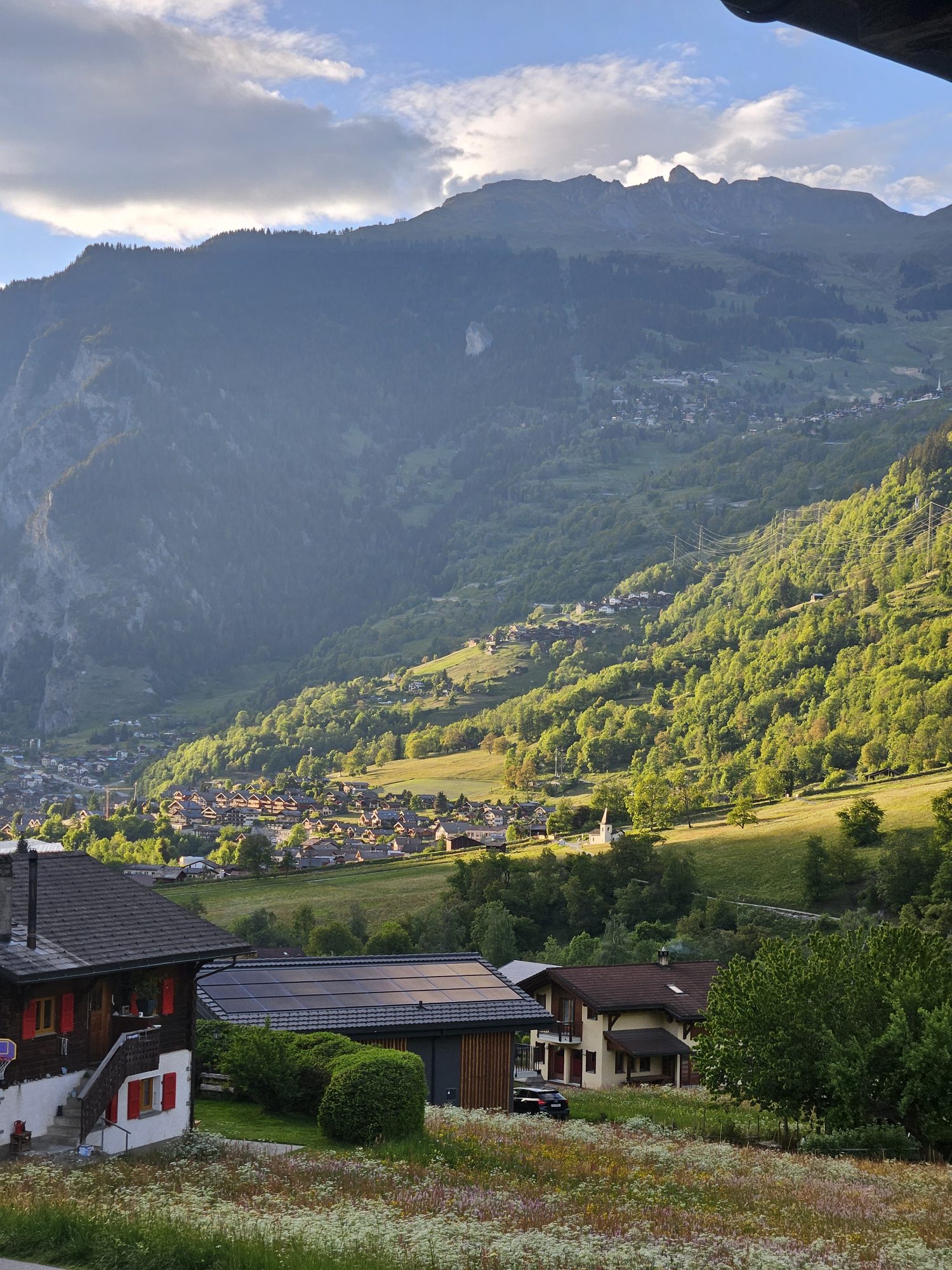 Evening light over the Val de Bagnes valley with chalets and alpine meadows